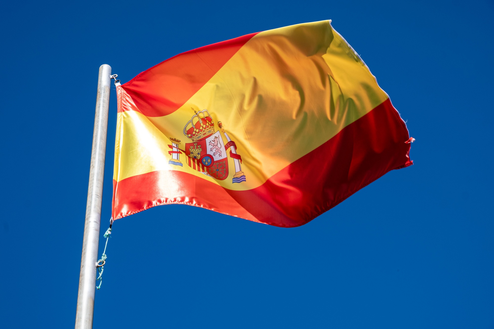a flag of Spain waving in the wind