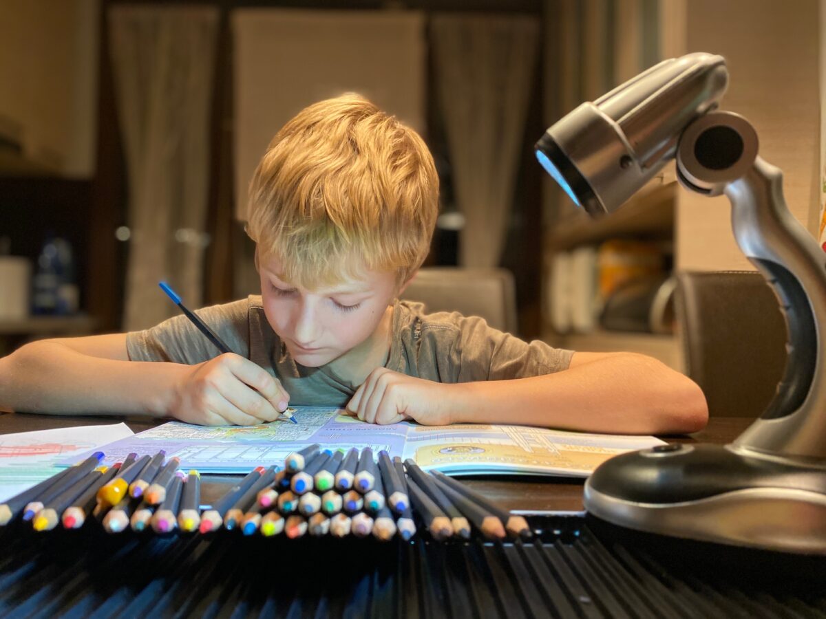 Boy drawing with colors pencils