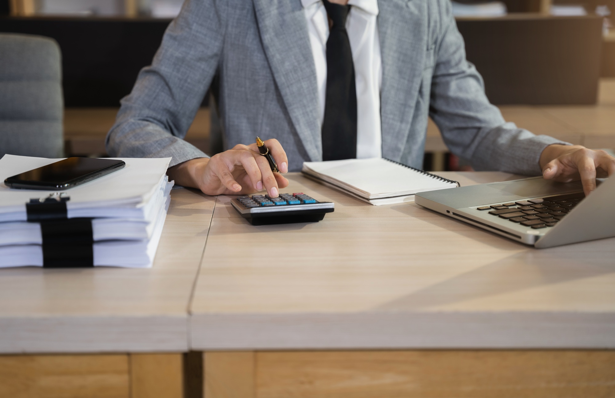 Businessmen are calculating income-expenditure.