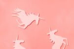 Creative unicorn pattern on trendy coral color background. Abstract art texture Minimal fantasy