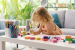 Cute girl coloring with markers
