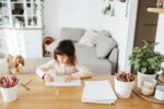 Cute preschooler girl learning home. Homeschooling, distance learning for kids.