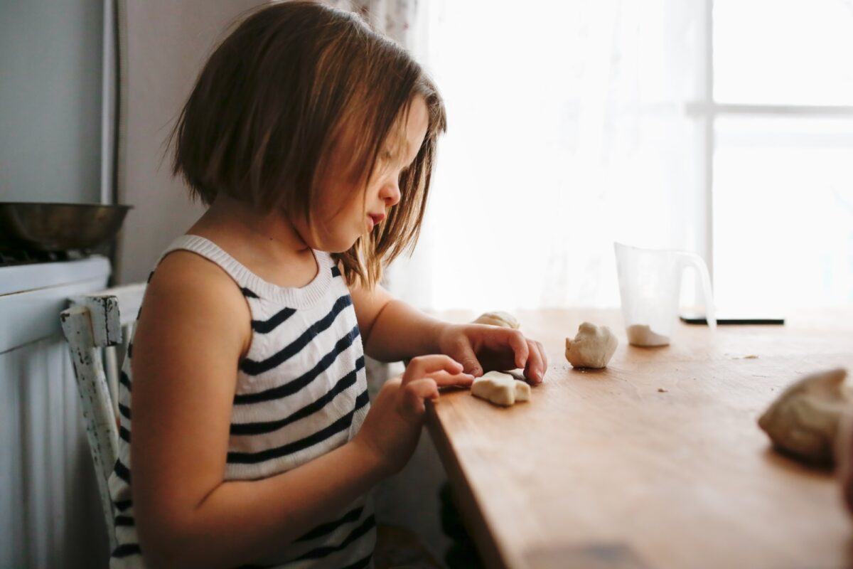 Girl child sculpts from salt dough, creativity at home
