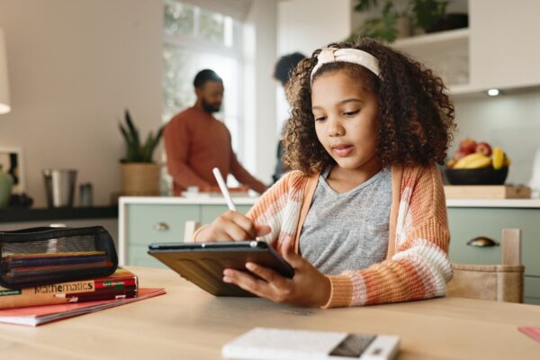 Girl kid, home and drawing on tablet for homeschool, learning and growth or development of motor sk