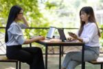 Outdoor business woman colleagues working together discussing starting a business project.