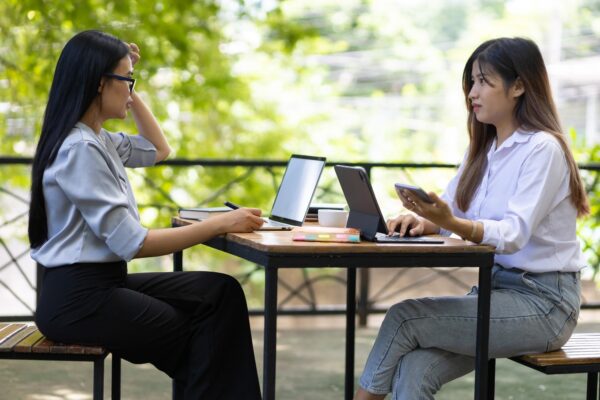 Outdoor business woman colleagues working together discussing starting a business project.