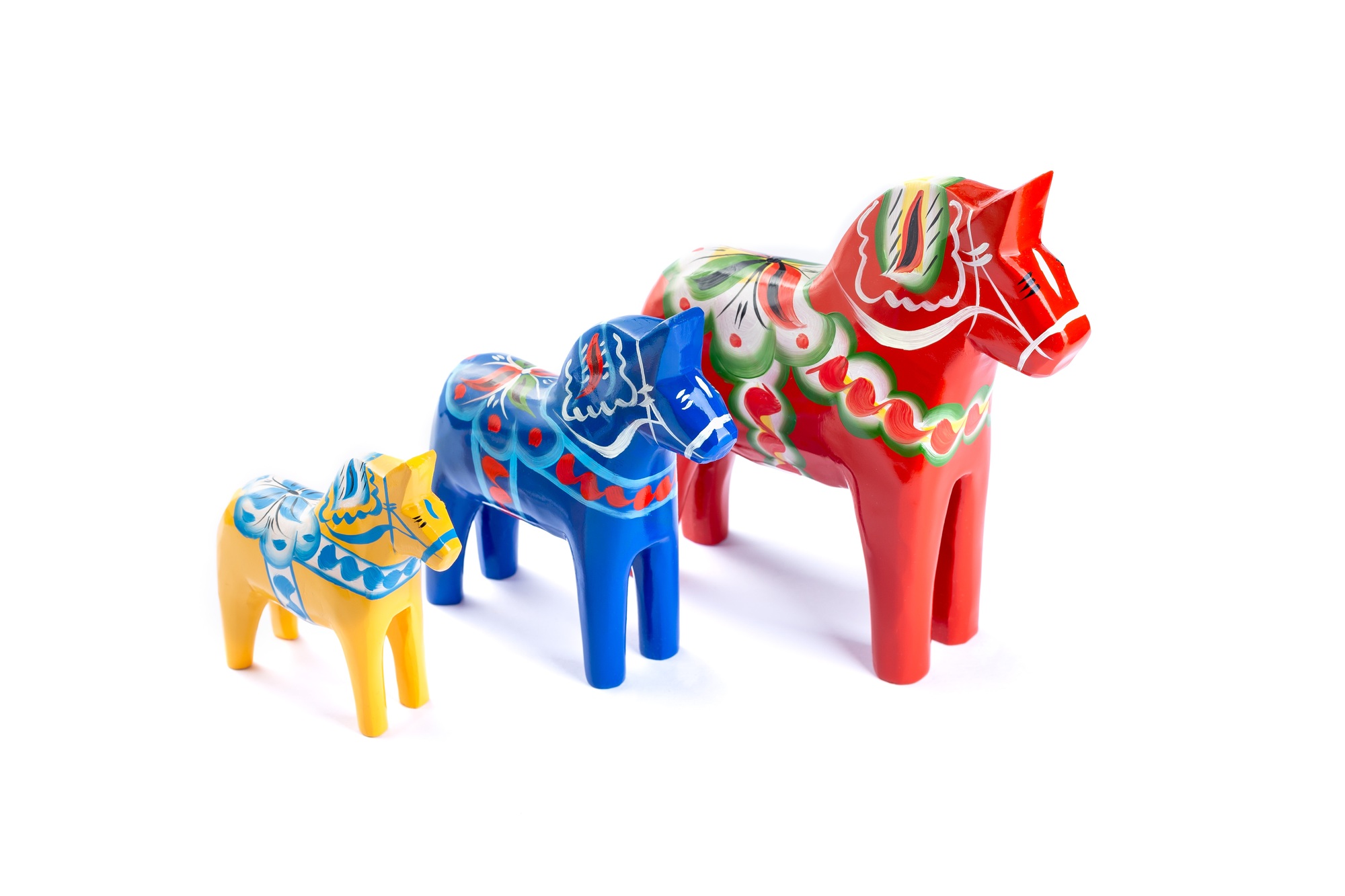 Swedish traditional souvenir Dala or Dalecarlian horses, different colors and sizes, isolated